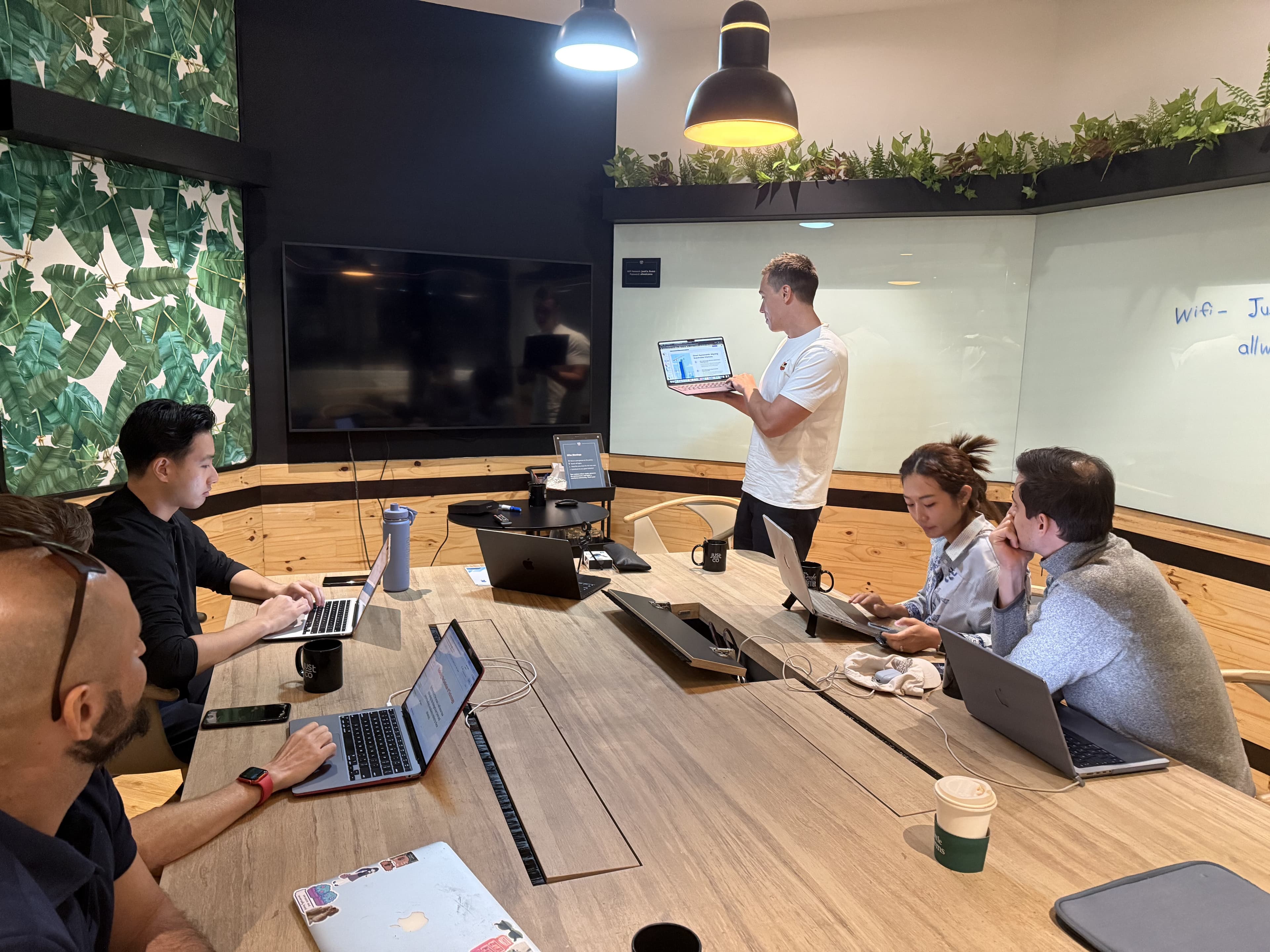 Alan Brown teaching adults around a long table during a corporate AI workshop