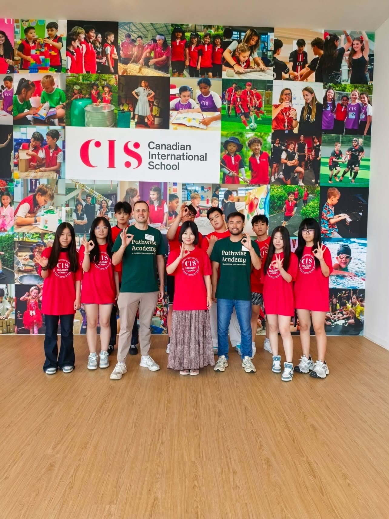 A small group of students posed with two Pathwise Academy instructors after a holiday camp