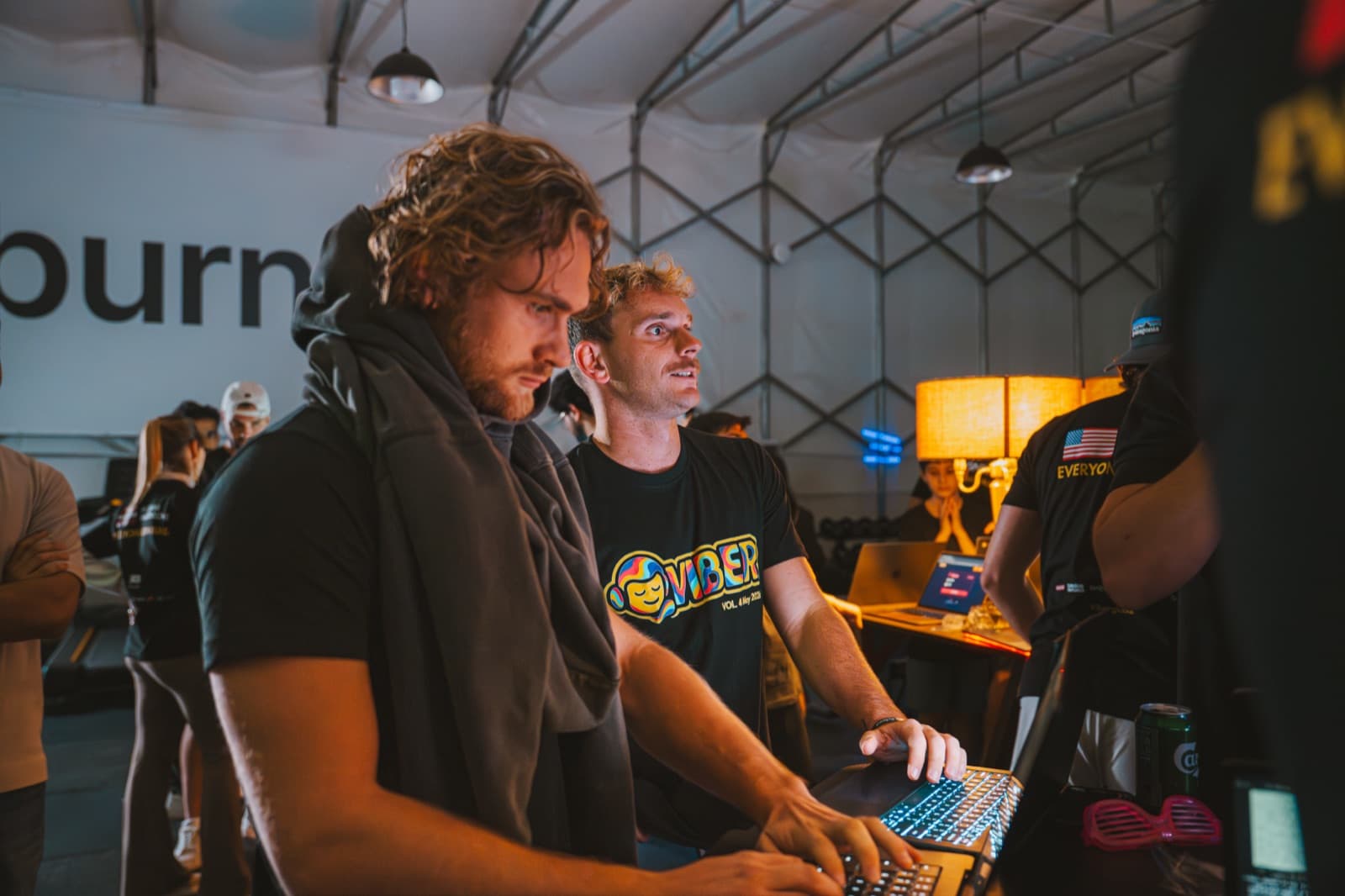 Two teammates building together on a laptop at a Pathwise and Viber company hackathon