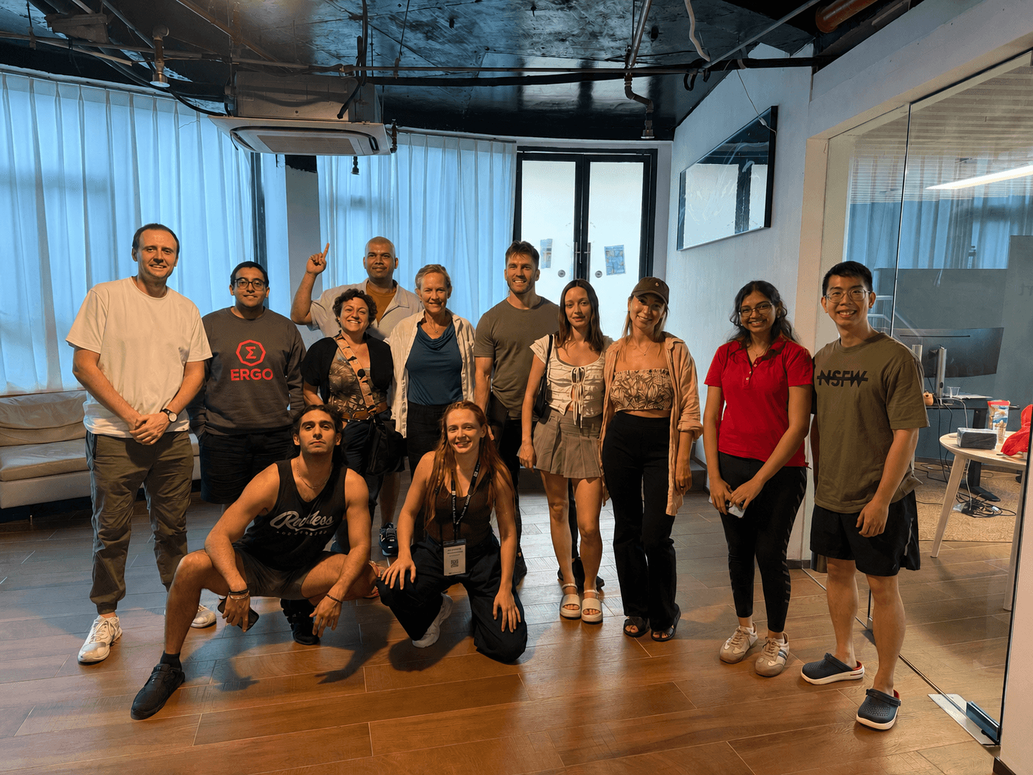 Pathwise Academy adult cohort posed together at the end of a hands-on AI session, instructor and students mid-laugh