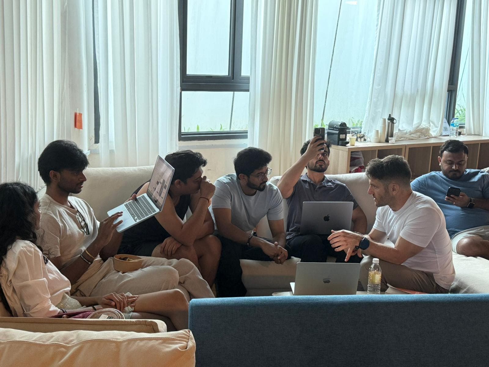 Adult workshop participants discussing their laptop projects together